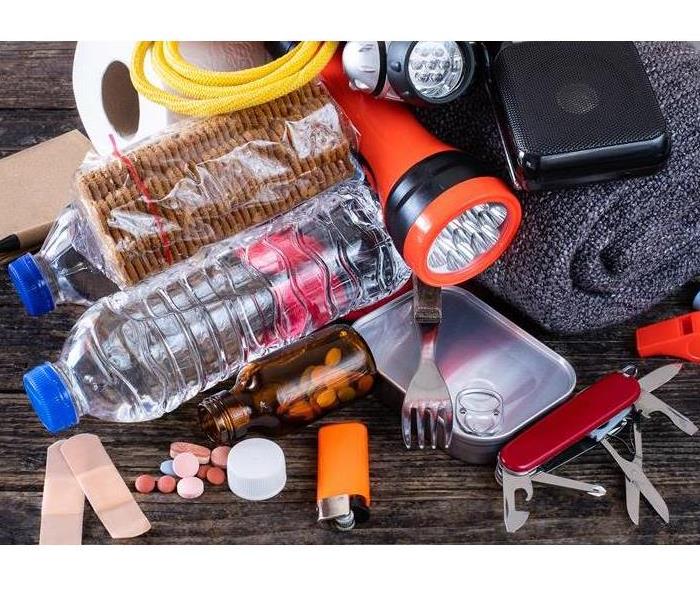 Emergency Prep Kit with water, food, tactical equipment, and flashlights