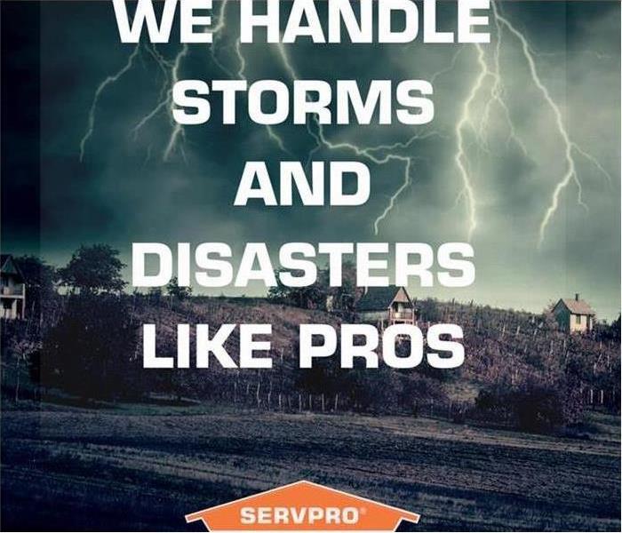 SERVPRO logo on the bottom of the image. City in the back with a storm cloud. 